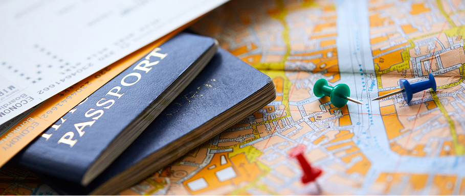 Passports and travel documents on a map